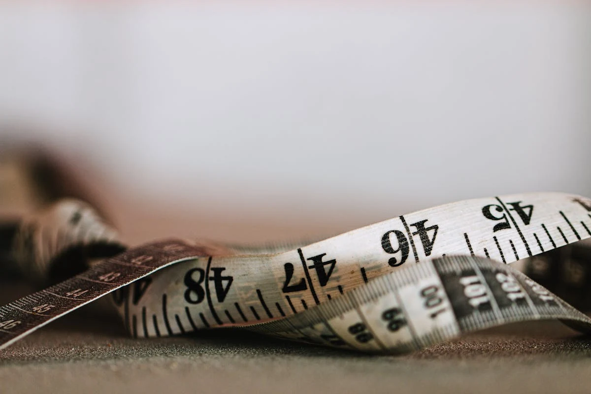 A retractable measuring tape extended along a desk