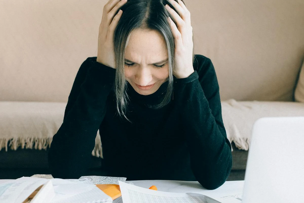 Tired person resting their head at a desk