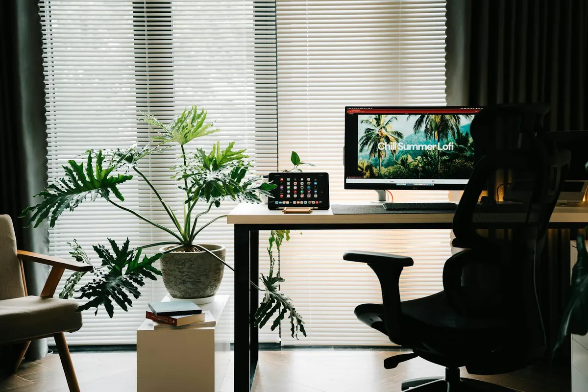 A premium standing desk next to a budget standing desk, side by side
