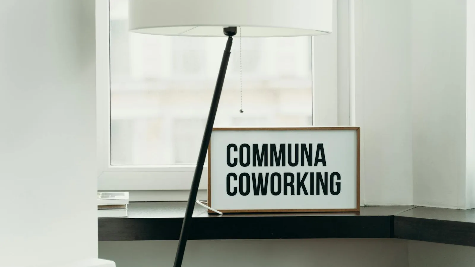 Modern office window with a Coworking sign on the sill