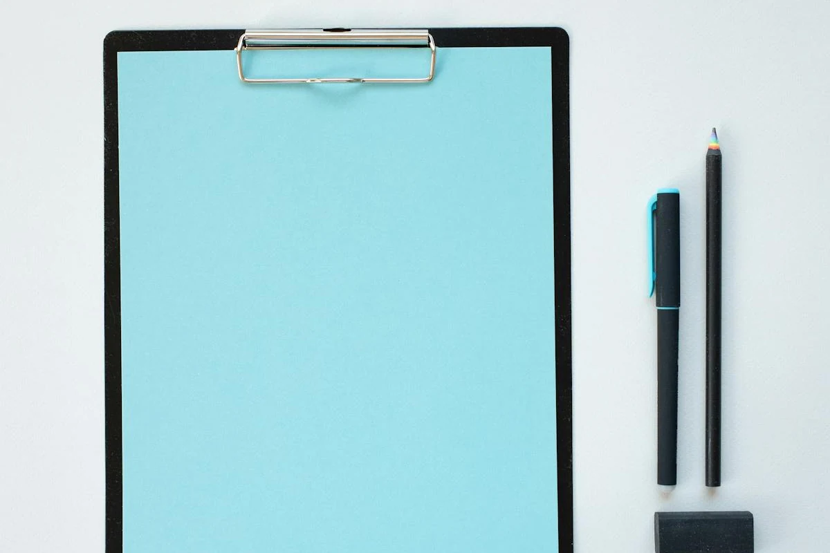 A clipboard with paper, used for taking notes