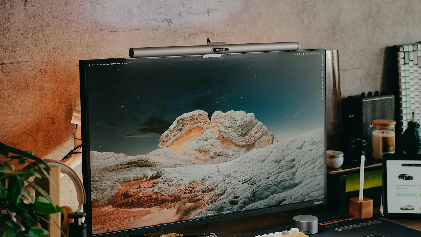 Single monitor on a desk with a light bar mounted above