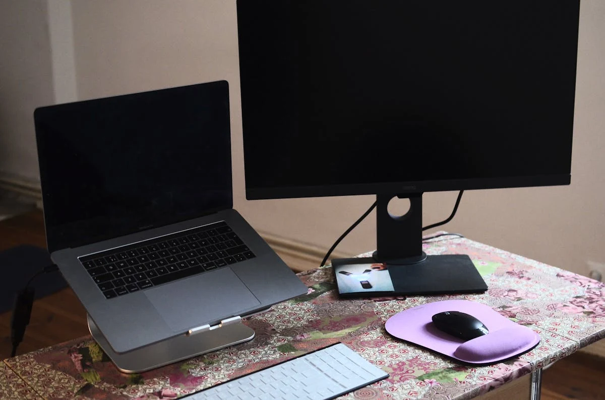 A laptop and external monitor side by side on a desk