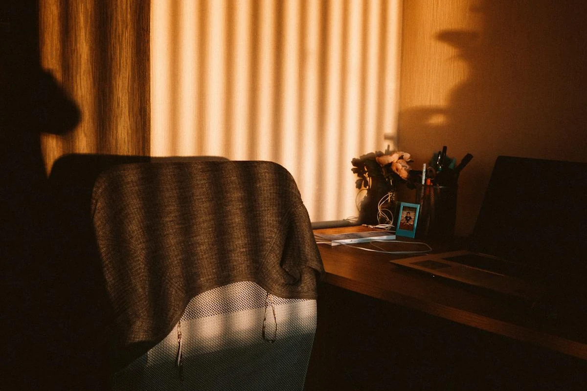 An empty office chair behind a vacant desk