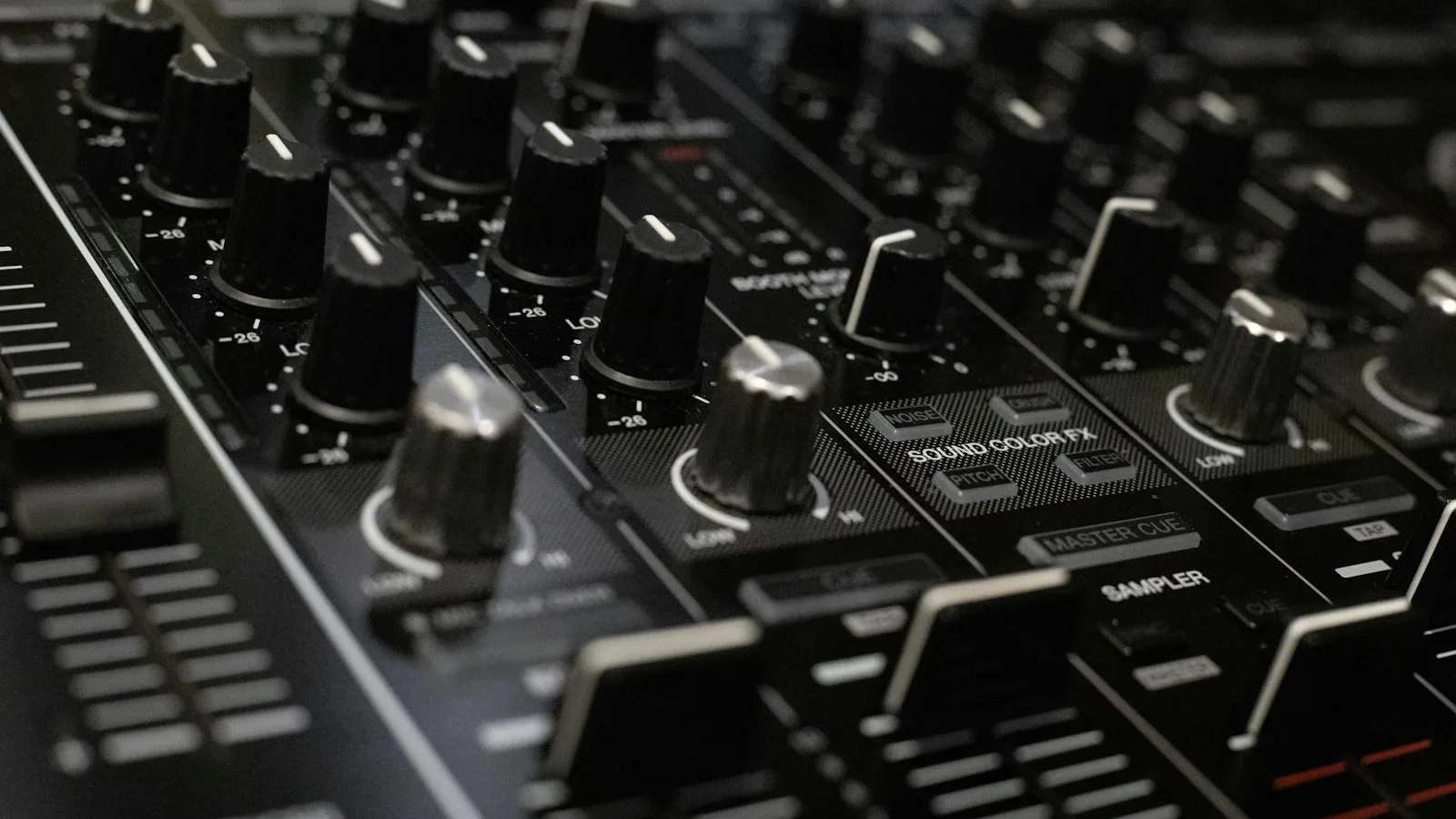 A close-up of a sleek black control panel with several illuminated controls