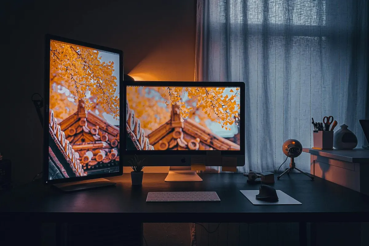 A standing desk with a multi-monitor setup